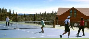 People playing tennis on the court at Courtwood Inn