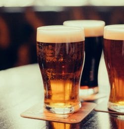 Three glasses of beer in pint glasses