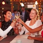 Four women toasting with wine