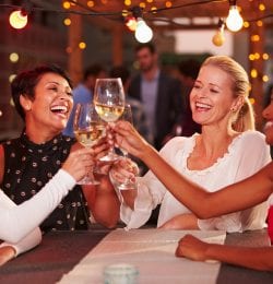 Four women toasting with wine