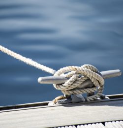 Detail image of yacht rope cleat on sailboat deck