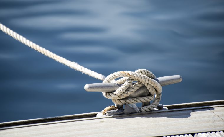 Detail image of yacht rope cleat on sailboat deck