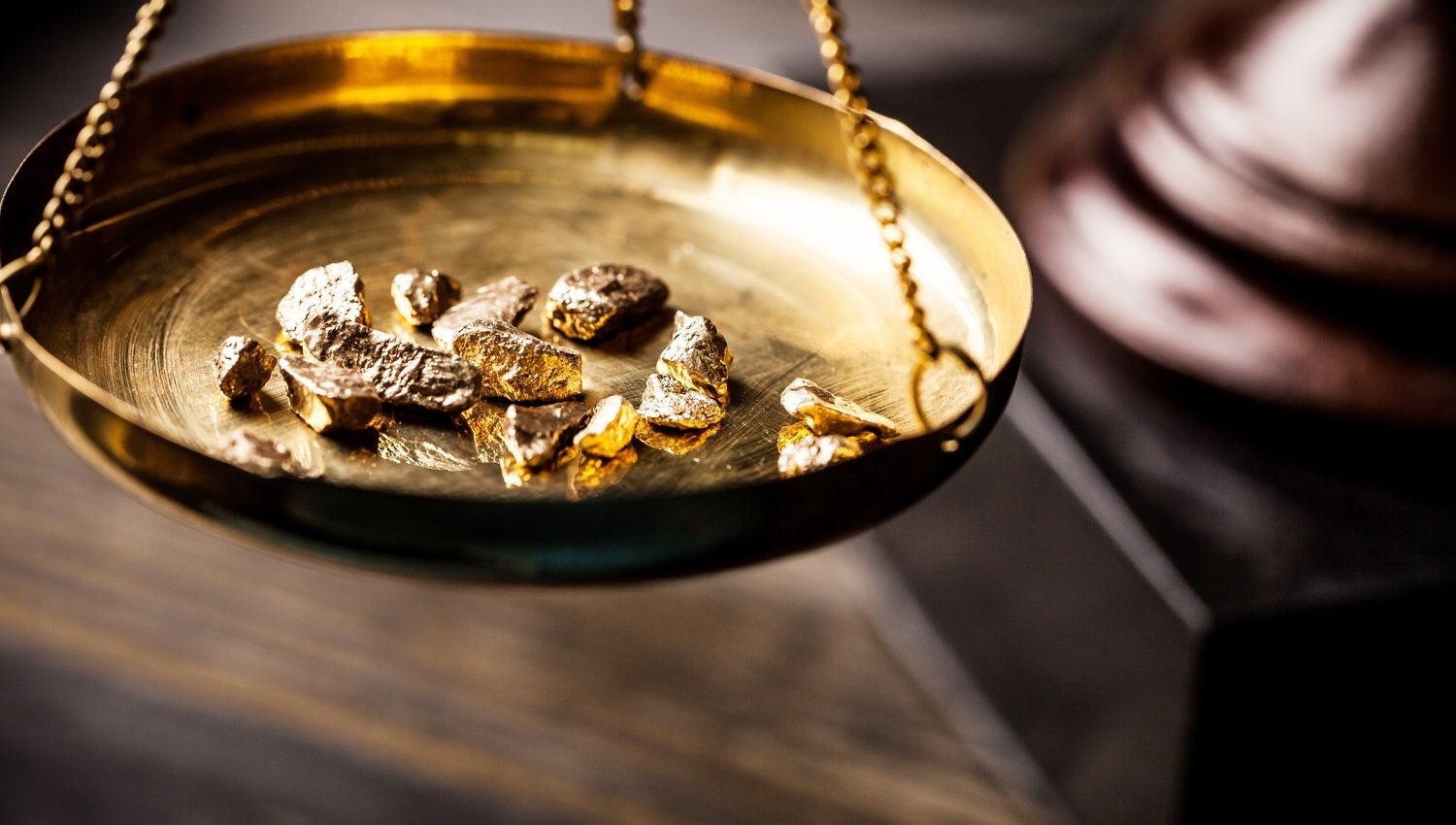 gold nuggets on an antique scale