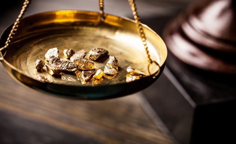 gold nuggets on an antique scale